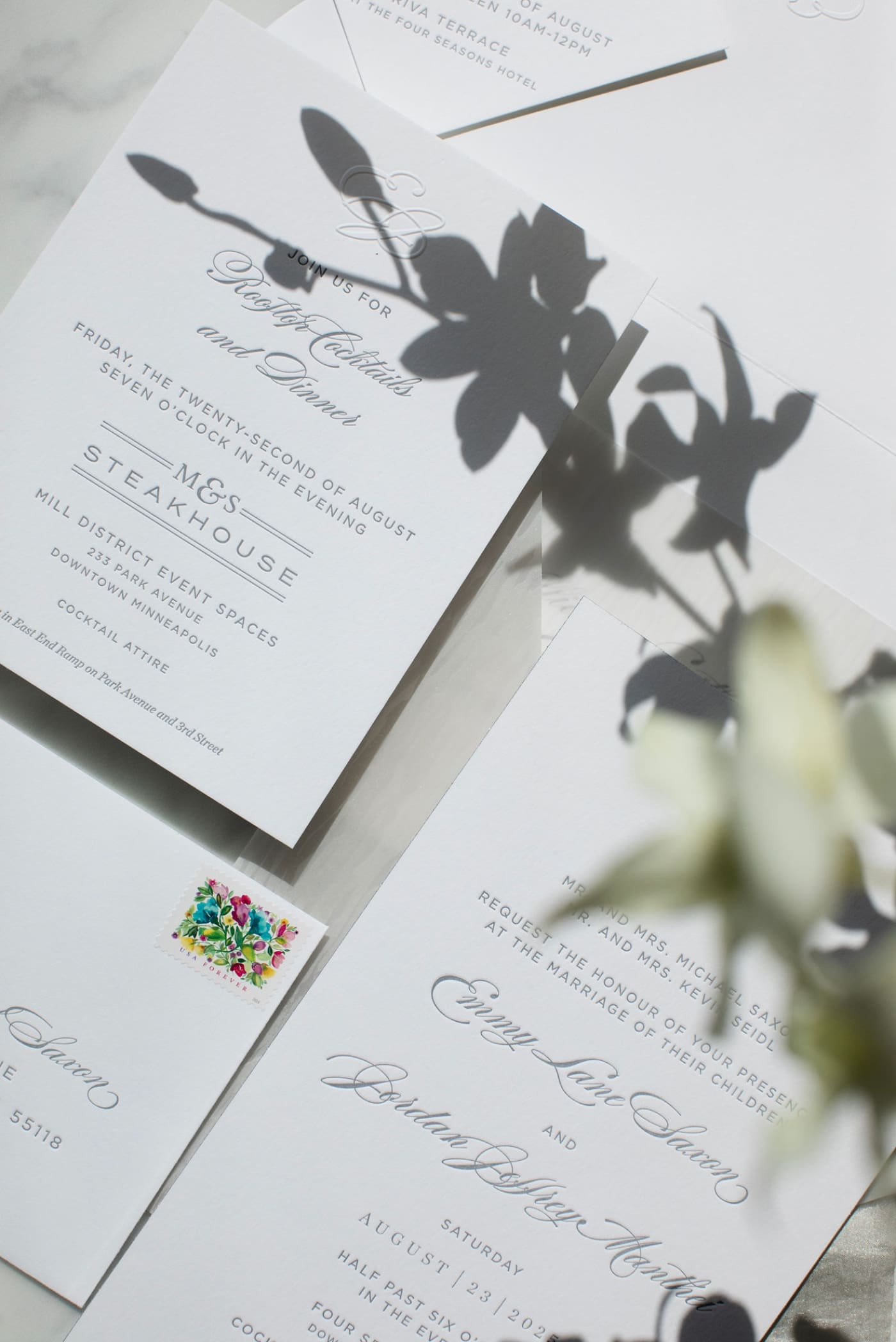 An all-white wedding invitation suite with blind embossing by Fig. 2 Design